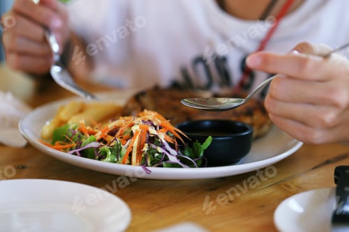 Preview: Favorite Food : People in white T-Shirt are eating delicious salad for lunch cloweup background