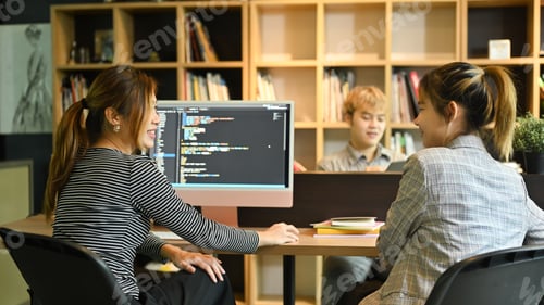 Preview: Team of software development brainstorming, working with coded data in corporate office.