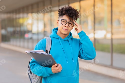 Preview: Thoughtful student adjusting glasses, touching head, copy space