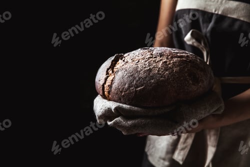 Preview: rustic bread in baker hand, healthy food