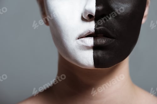 Preview: cropped view of woman with creative white and black bodyart on face, isolated on grey