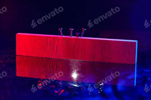 Preview: Screws screwed into a wooden beam in hard red light