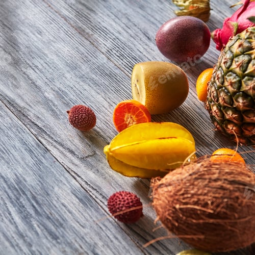 Preview: Tropical composition from exotic fruits with ripe pineapple, karambola, mango, passion fruit on a