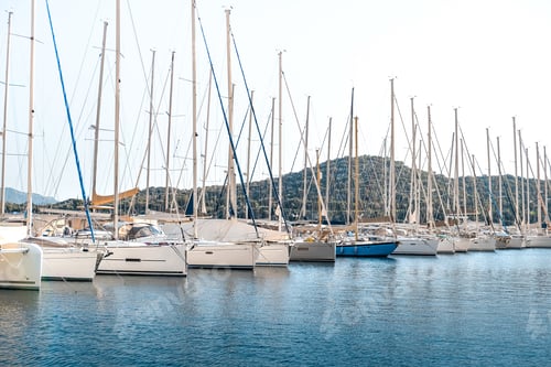 Preview: yacht sails through calm blue waters near a scenic coastal marina. This image embodies the essence o