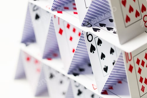 Preview: house of playing cards over white background