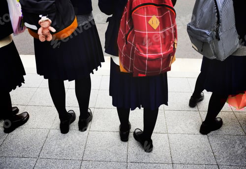 Preview: Students with Backpacks Standing on City Sidewalk