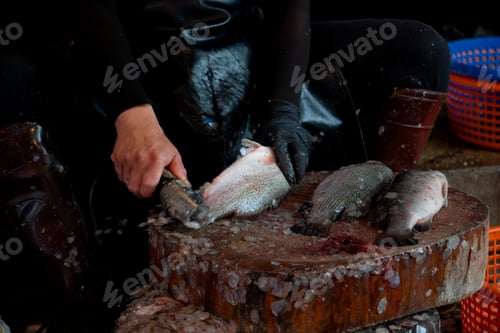 Preview: A man scales fish at a wet market in Hatyai, Thailand