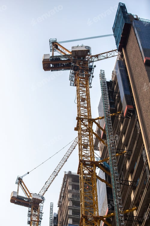 Preview: Construction site of a modern residential building with construction cranes.