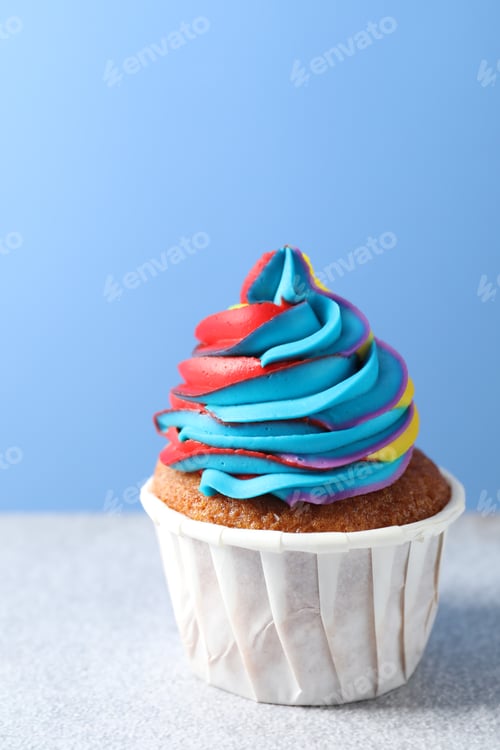 Preview: Colorful Iced Cupcake on a Light Blue Background