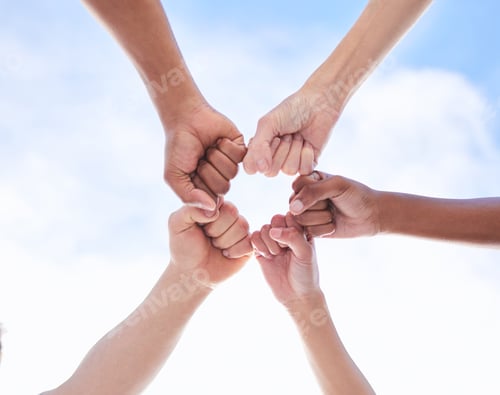Preview: Shot of a group of unrecognizable people making a circle with their fists outside