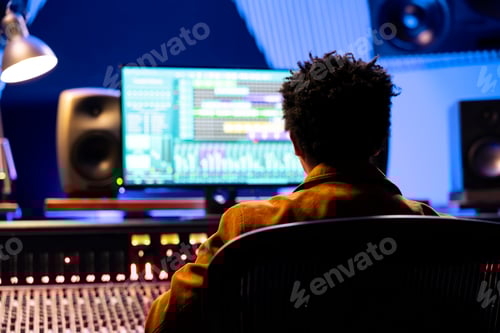 Preview: Adult Working in Recording Studio at Mixing Desk