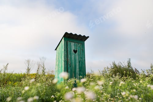 Preview: Vintage toilet. An outdoor rustic green toilet with a heart cut out on the door.