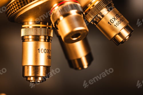 Preview: Close-up shot of professional scientific microscope with metal lens setting at medical laboratory