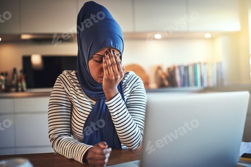 Preview: Young Arabic female entrepreneur looking stressed while working from home
