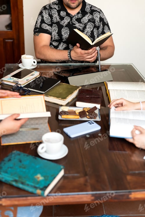 Preview: Writers reading and sharing ideas at table with books and coffee