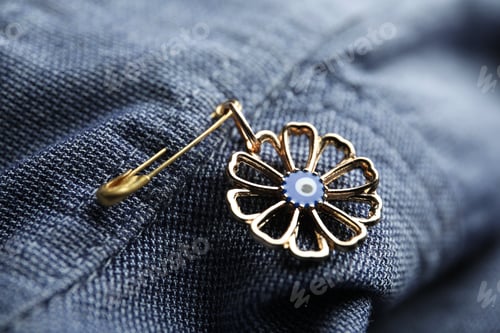 Preview: Evil eye safety pin on clothing, closeup