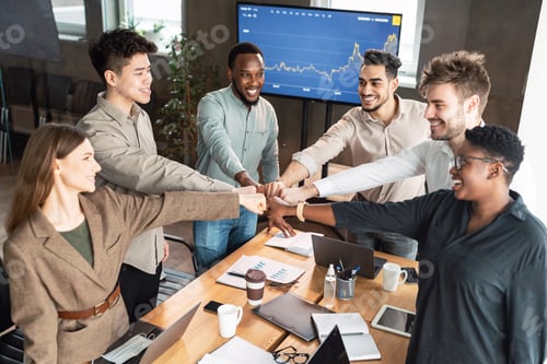 Preview: Portrait of smiling diverse business people giving fist bump