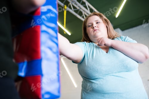 Preview: Strong Obese Woman Boxing in Gym