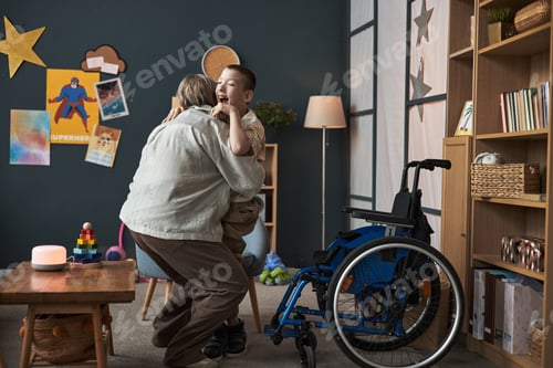 Preview: Embracing Young Boy in Wheelchair in Cozy Living Room