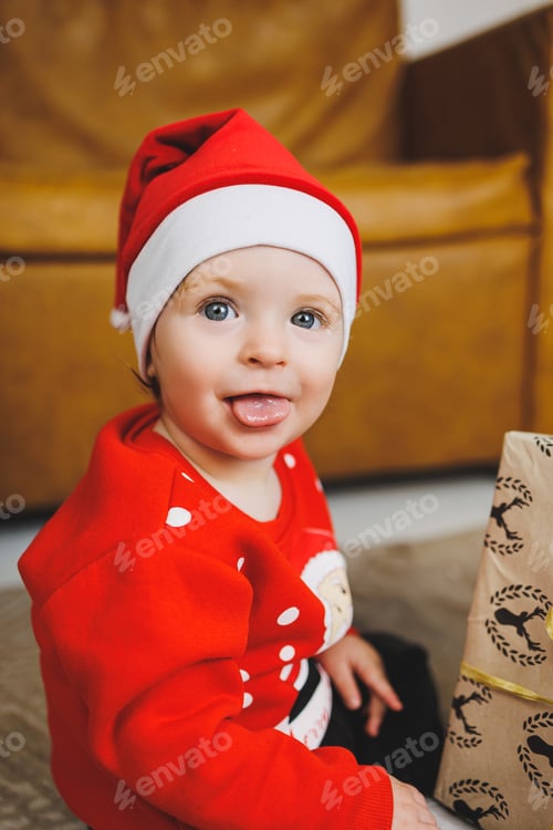 Preview: little one-year-old boy near the Christmas tree. an idea for a children's photo for the new year.