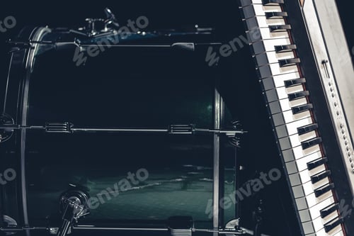 Preview: Drum and musical keys on a black background, close up.