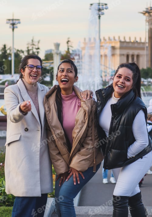 Preview: Friends laughing outdoors in a cold day