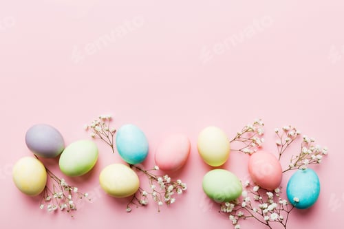Preview: Happy Easter composition. Easter eggs on colored table with gypsophila
