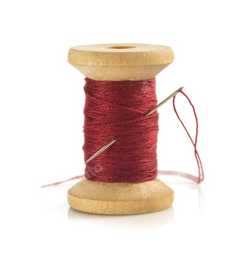 Preview: spool of thread and needle on white