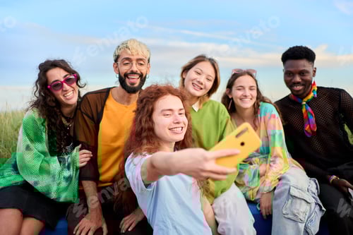 Preview: Multi-ethnic group smiling boys and girls taking selfie outdoors. People enjoying weekend.