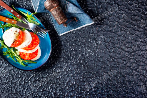 Delicious Caprese Salad with Arugula and Pepper Grinder