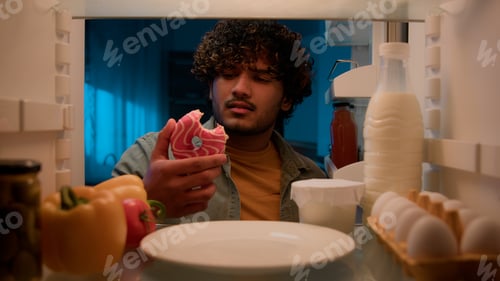 Preview: Point of view POV from inside refrigerator hungry Indian man Arabian guy male at night kitchen open
