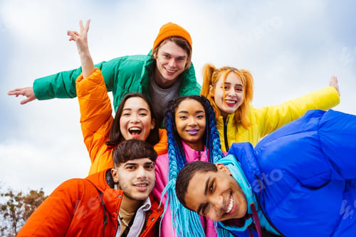 Preview: Multiracial group of young friends meeting outdoors in winter