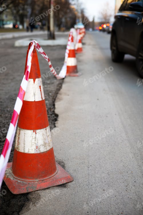 Preview: Under construction board sign on the closed road with arrow sign and traffic cone. Caution symbol un