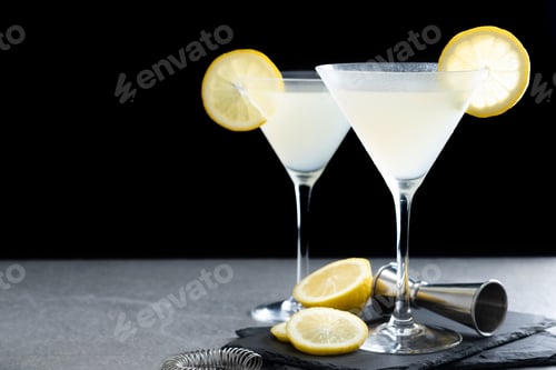 Preview: Lemon drop martini cocktail on gray stone and black background