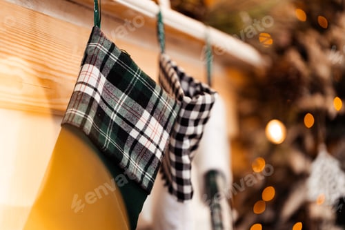 Preview: Festive stockings hanging on fireplace at Christmas