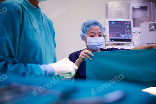 Preview: Surgical Team Working On Patient In Hospital Operating Theatre