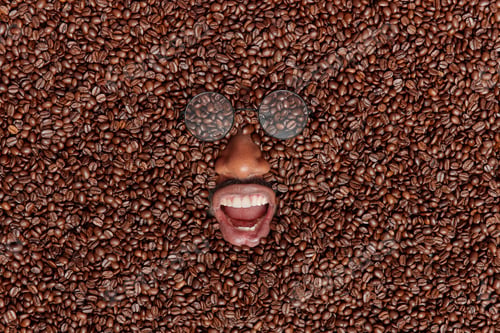 Preview: Happy dark skinned male model fully covered with brown coffee beans keeps mouth opened wears transpa