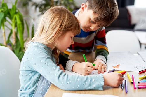 Preview: Close up of brother helping his sister with her homework