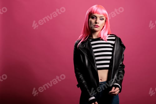 Preview: Young adult with pink hair wearing biker leather jacket