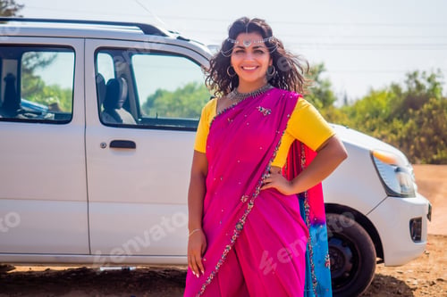 Preview: Portrait of young Indian woman in a traditional pink sari and costume jewelry