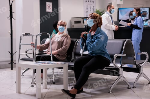 Preview: Diverse patients sitting in waiting room lobby at clinic