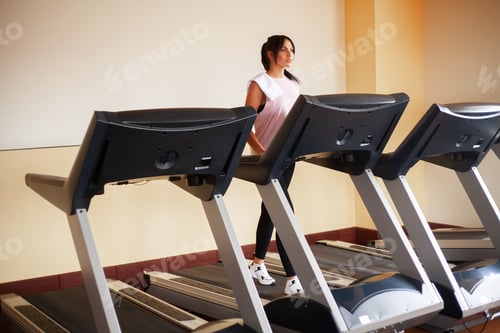 Preview: Fit women running on treadmills doing cardio training in a gym,Healthy lifestyle concept