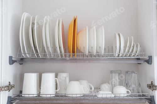 Preview: Dish drying metal rack with big nice white clean kitchenware. Traditional wall cabinet kitchen