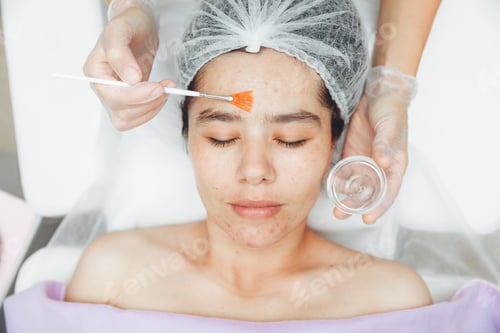 Preview: A cosmetologist does facial care and apply a face mask. cleansing a heavily soiled face.