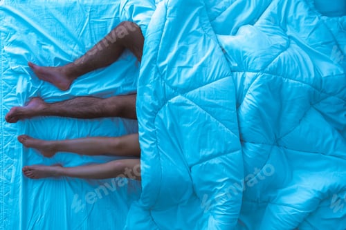 Preview: The couple sleeping under the duvet. evening night time. view from above