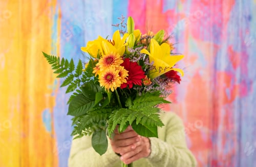 Preview: Mature woman hidden by a bouquet of flowers. Celebration concept. Valentine's Day Women's Day