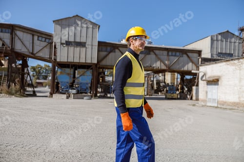 Preview: Male engineer standing outdoors at industrial site