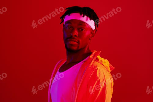 Preview: Ill see you at the gym. Red filtered shot of a young sportsman posing in the studio.
