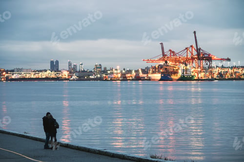 Preview: Young couple embracing on coastline and industrial cargo ship on harbor in Stanley Park