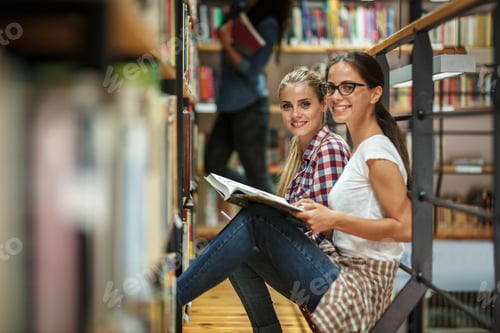 Preview: Group of female students study in the college library.